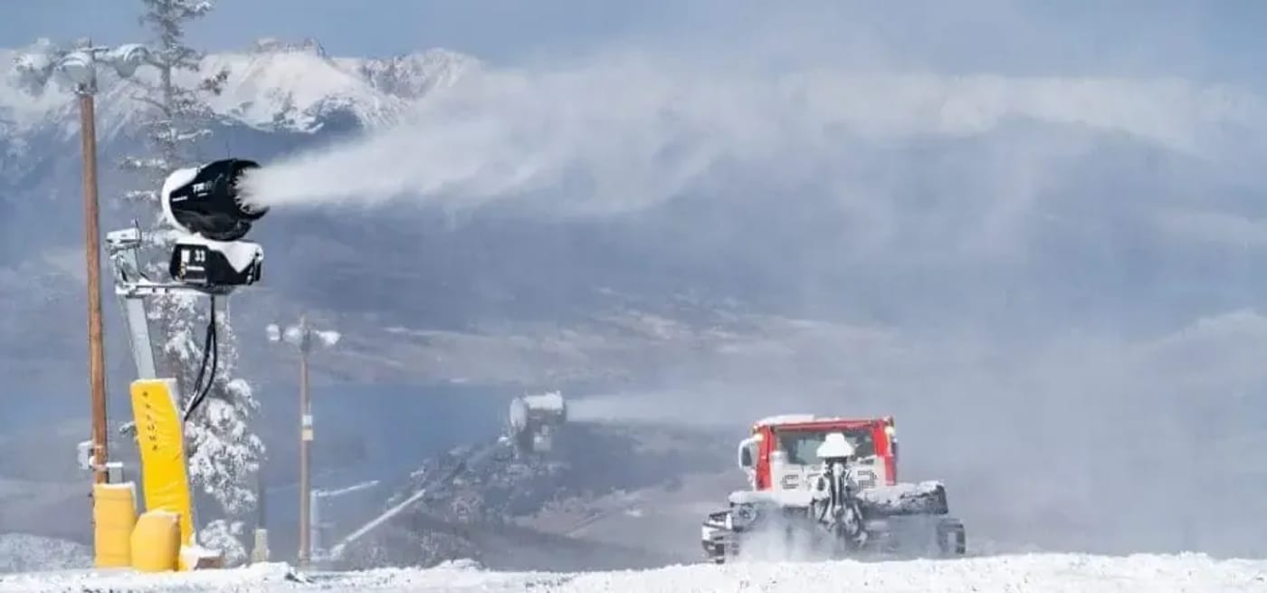 Alpine ski racer carving through a gate on a snowy World Cup course