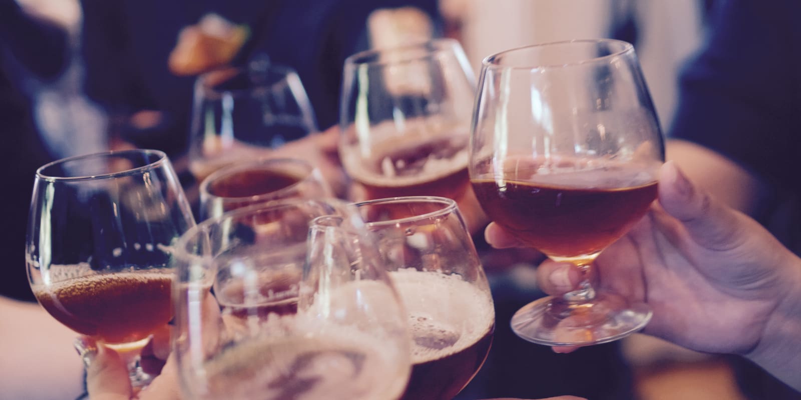 Friends raising glasses together in a toast
